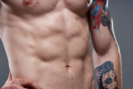 man with a pumped-up torso tattoo on his armsの写真素材