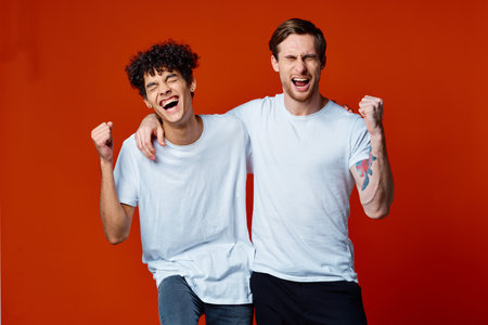 Two cheerful friends in white t-shirts communicationの写真素材