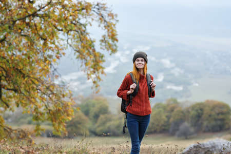 woman hiker travel in the mountains autumn trees vacation