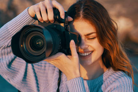 happy woman photographer outdoors in mountains professional landscape modelの写真素材