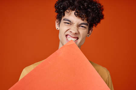 man with curly hair holding a poster in hands Copy Space cropped view