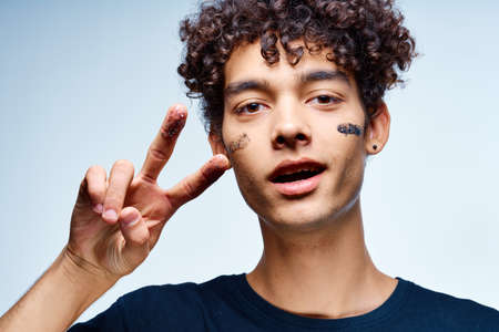 emotional man with curly hair cosmetics facial close-upの写真素材