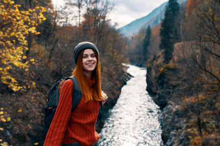 cheerful woman hiker mountains river landscape travelの写真素材