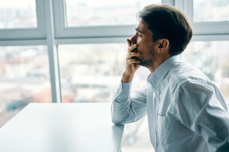 Man sitting at the table office emotions depression stress. High quality photoの写真素材