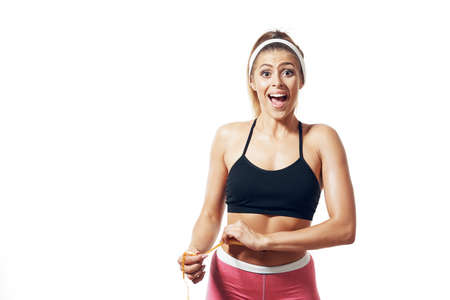 cheerful sportive woman workout measuring waist