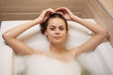 woman lies in bathroom relaxing in hygiene lifestyle
