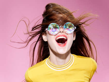 cheerful woman fashion glasses glamor pink background modelの写真素材