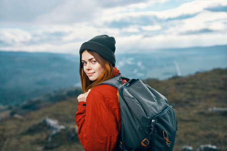 woman jacket hats looking at the mountain in the distance blue sky clouds Model backpackの写真素材