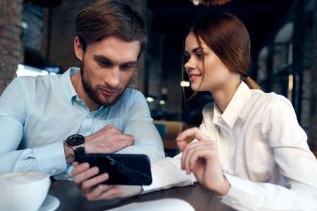 business man and woman in a cafe communication telephone work