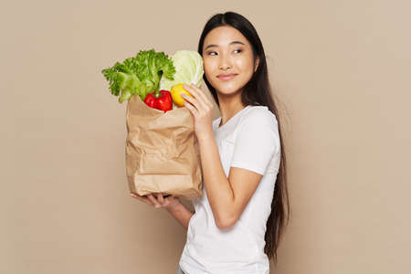 pretty asian woman food package homework vegetables food dietの写真素材
