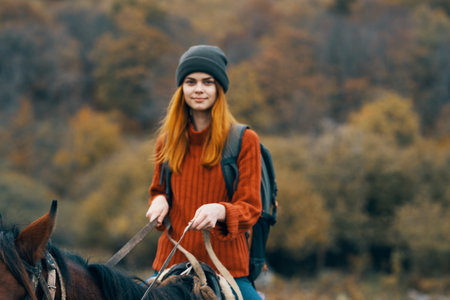 woman hiker mountains nature riding horse funの写真素材