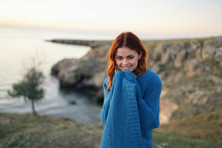 woman on nature blue plaid admires the landscape travelの写真素材