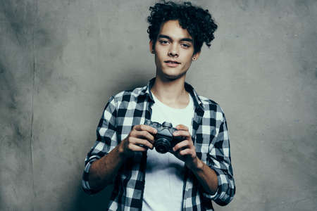man with camera indoors on fabric background t-shirt model curlsの写真素材