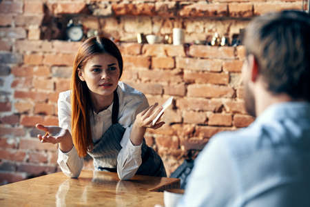 cheerful female waiter taking order restaurant service workの写真素材