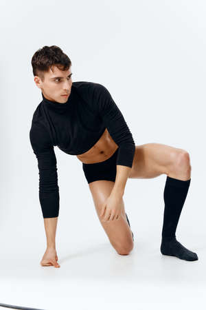 man in short t-shirt panties and socks pumped up torso striptease modelの写真素材