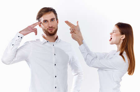 cheerful employees gesturing with their hands to work light background shirt communication modelの写真素材
