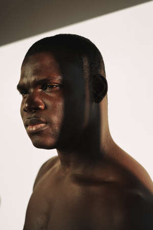 male african appearance bare shoulders studio fashion close-up