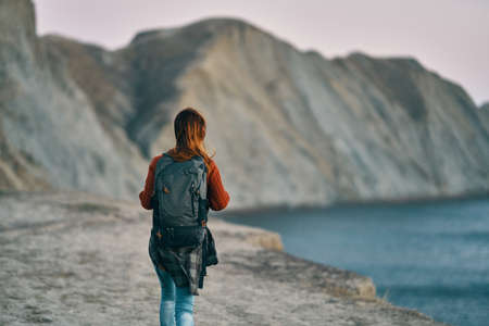 woman in the mountains near the sea and rocks in the background nature fresh airの写真素材