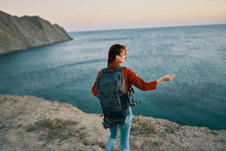 traveler with backpack near the sea in nature fresh air landscape sunsetの写真素材