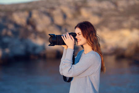 woman tourist with camera on nature rocky mountains travel professionalsの写真素材