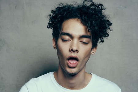 cute guy curly hair emotions studio cropped view