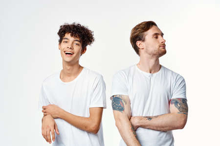 funny two men in white t-shirts are standing side by side isolated background