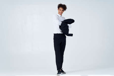 curly guy in suit jacket in hands posing lifestyle modern style