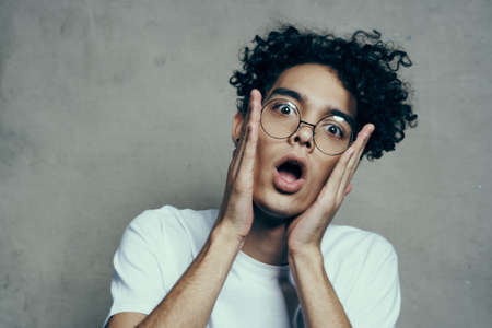 guy with curly hair emotions glasses fashion studio close-upの写真素材