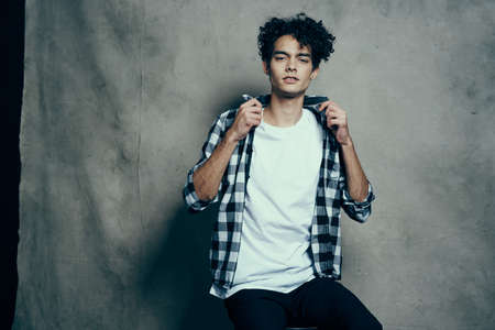 cute guy plaid shirt fun curly hair studio lifestyleの写真素材