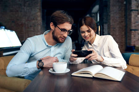 Business couple sitting at a table in a cafe breakfast communication workの写真素材