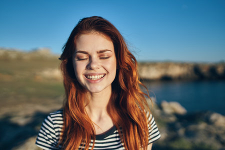 happy woman in the mountains on the beach near the lake vacation relax smile modelの写真素材