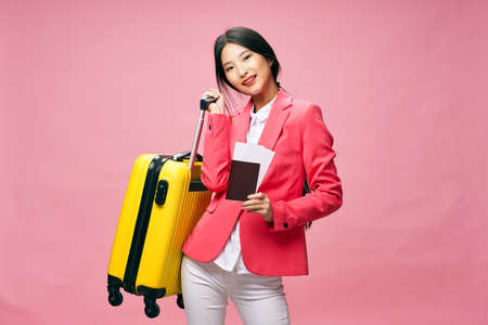 woman in a jacket suitcase vacation travel passport and plane ticketの写真素材