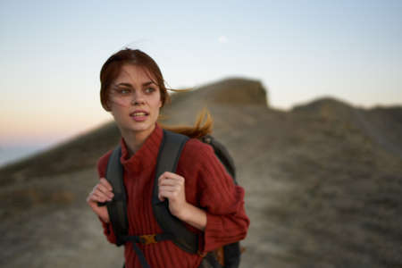 young traveler resting in nature in the mountains near the rocks in the open airの写真素材