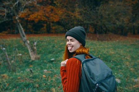 happy traveler resting in nature with backpack on her back back viewの写真素材