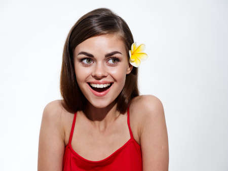 happy woman smile red t-shirt brunette yellow flowerの写真素材