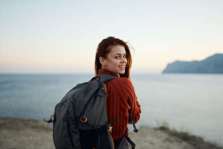 woman in sweater resting in the mountains outdoors vacation travel tourism