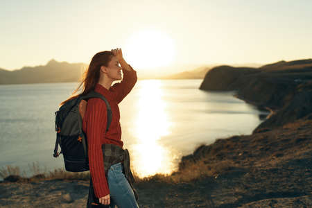 woman hiker with backpack outdoors in rocky mountains fresh air landscapeの写真素材