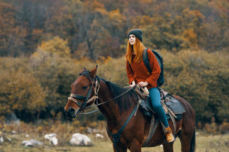 woman riding a horse on nature mountains travel adventureの写真素材