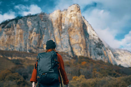 woman hiker backpack travel mountains clouds natureの写真素材