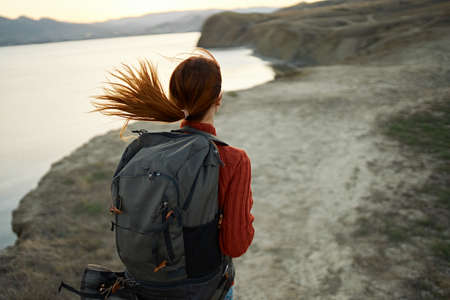 portrait of a happy traveler in the mountains outdoors near the sea fun landscape sand