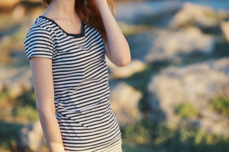 joyful woman in mountains outdoors and striped t-shirt landscape mountains sea riverの写真素材