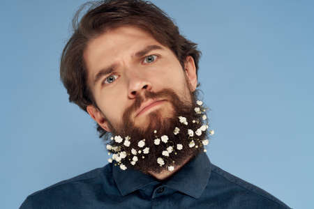 cute bearded man with flowers in his hair lifestyle hair careの写真素材