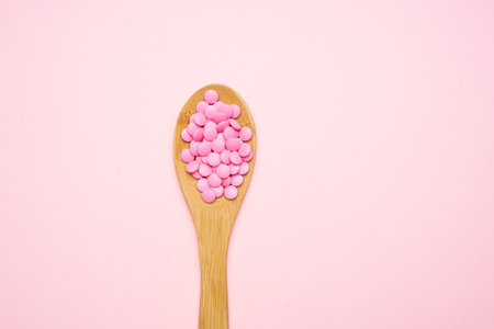 pink pills in spoon isolated background medicine pharmacyの写真素材