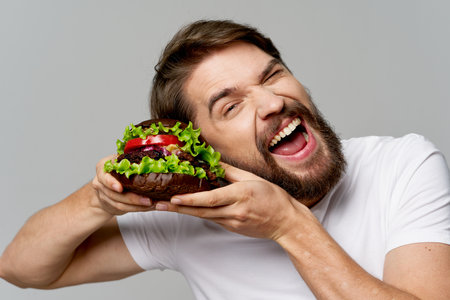 bearded man hamburger fast food diet food fun closeupの写真素材