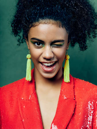 woman with curly hair red jacket decoration luxury close-up