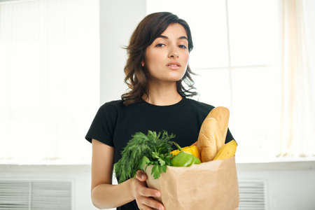 cute brunette package with health products delivery from supermarketの写真素材