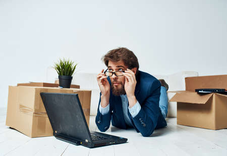 business man office boxes with things unpacking interior laptopの写真素材