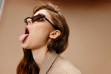 emotional woman showing tongue to the side grimacing glasses model