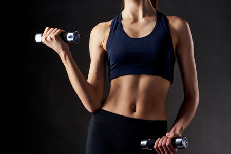woman with dumbbells in hands fitness motivation workout slim figureの写真素材