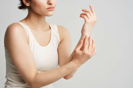 brunette in white tank top clean skin health hygieneの写真素材